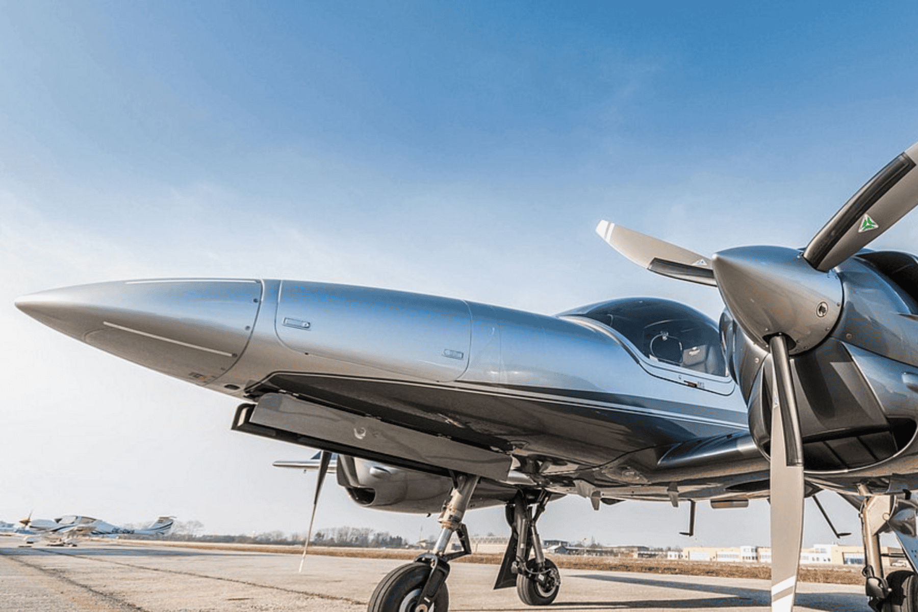 Close-up of a sleek modern airplane on runway.