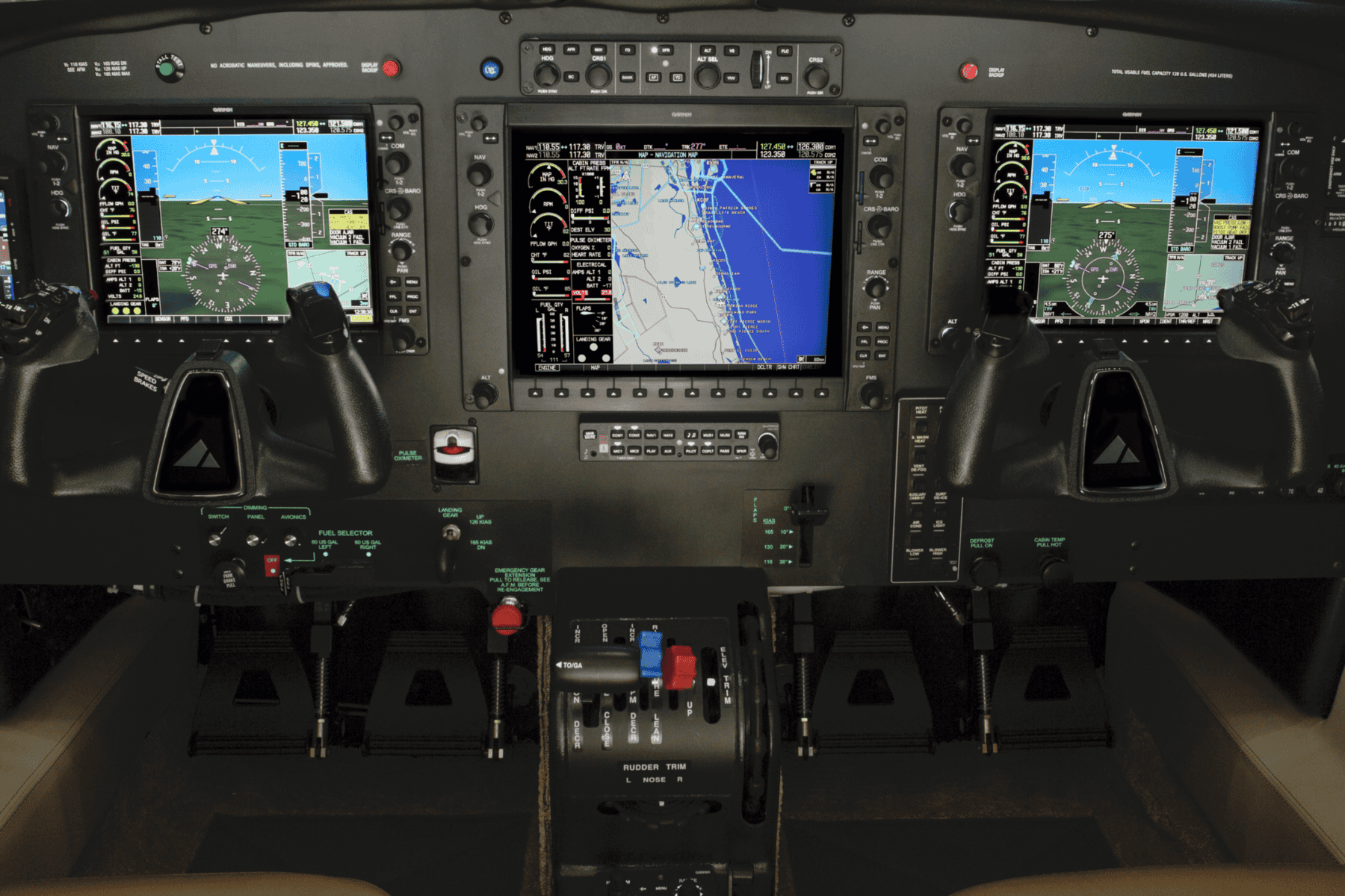 Aircraft cockpit with digital navigation displays and controls.