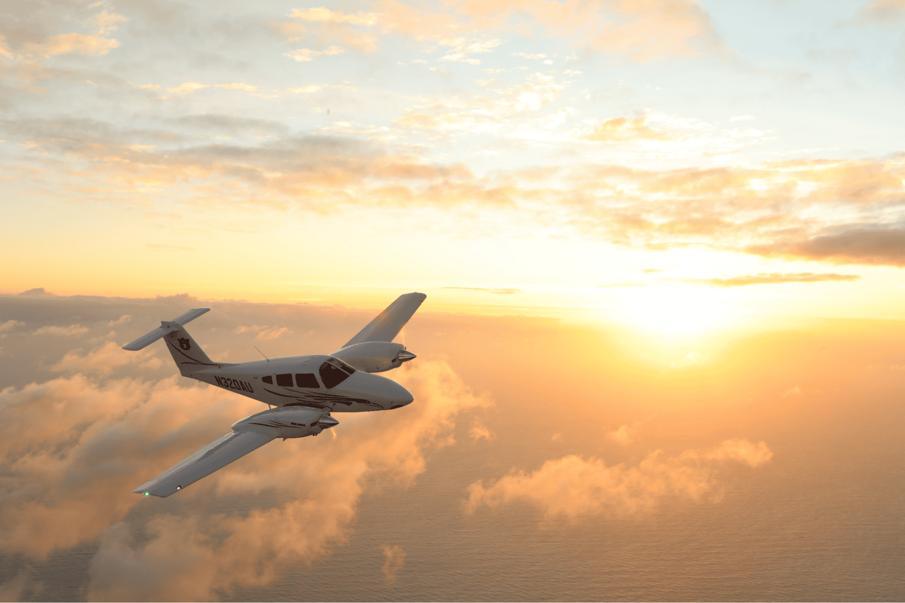 Aircraft flying over ocean at sunset