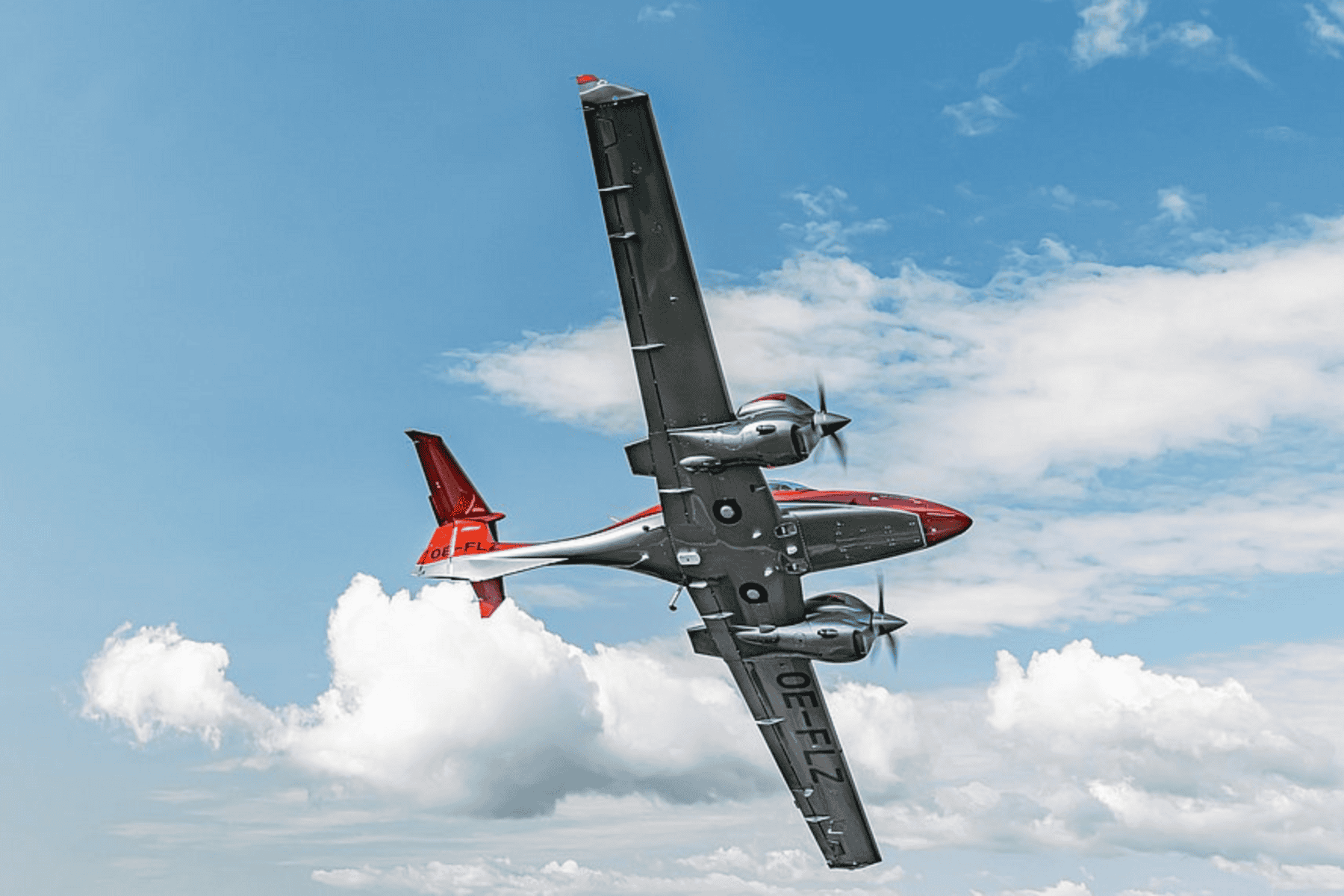 Small propeller airplane flying in blue sky.