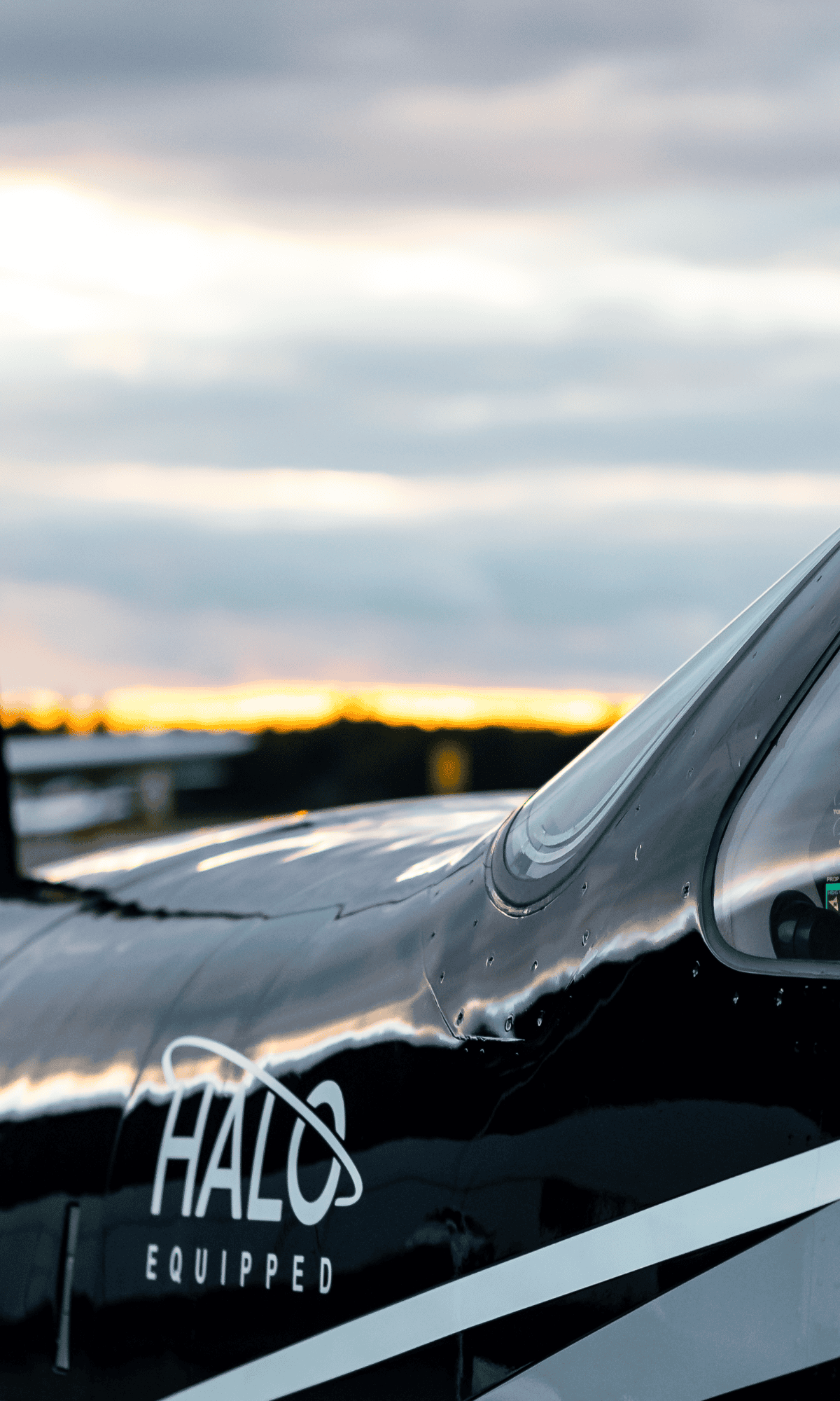 Aircraft with 'Halo Equipped' marking at sunset