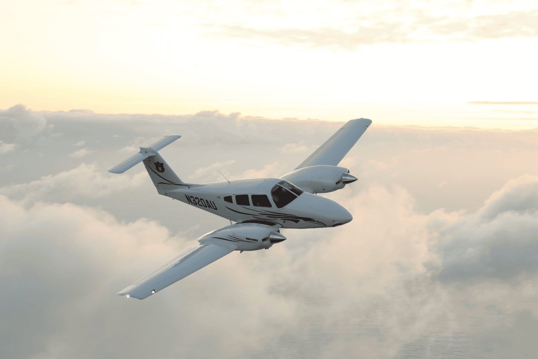 Light aircraft flying above clouds at sunset.