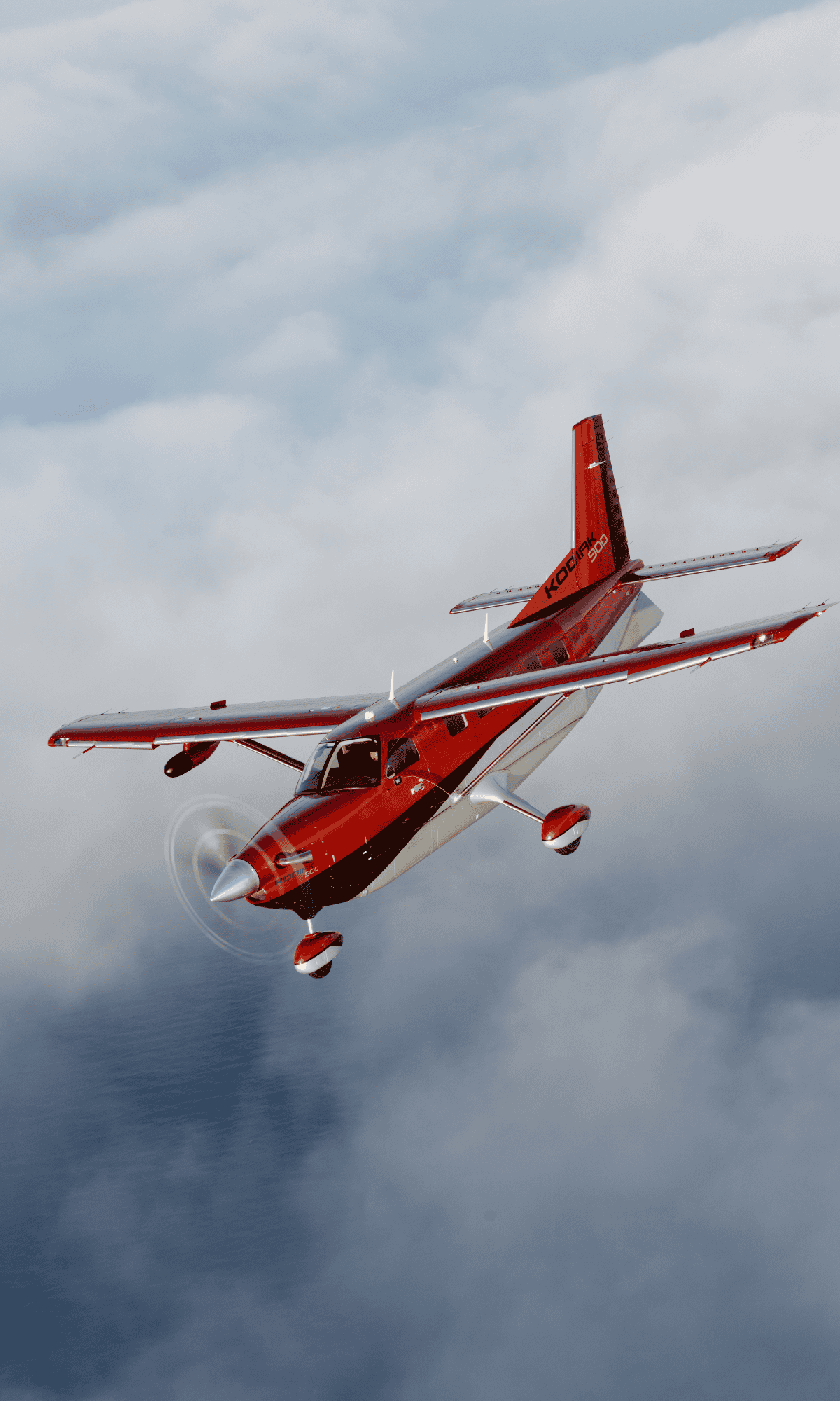 Red airplane flying above the clouds.