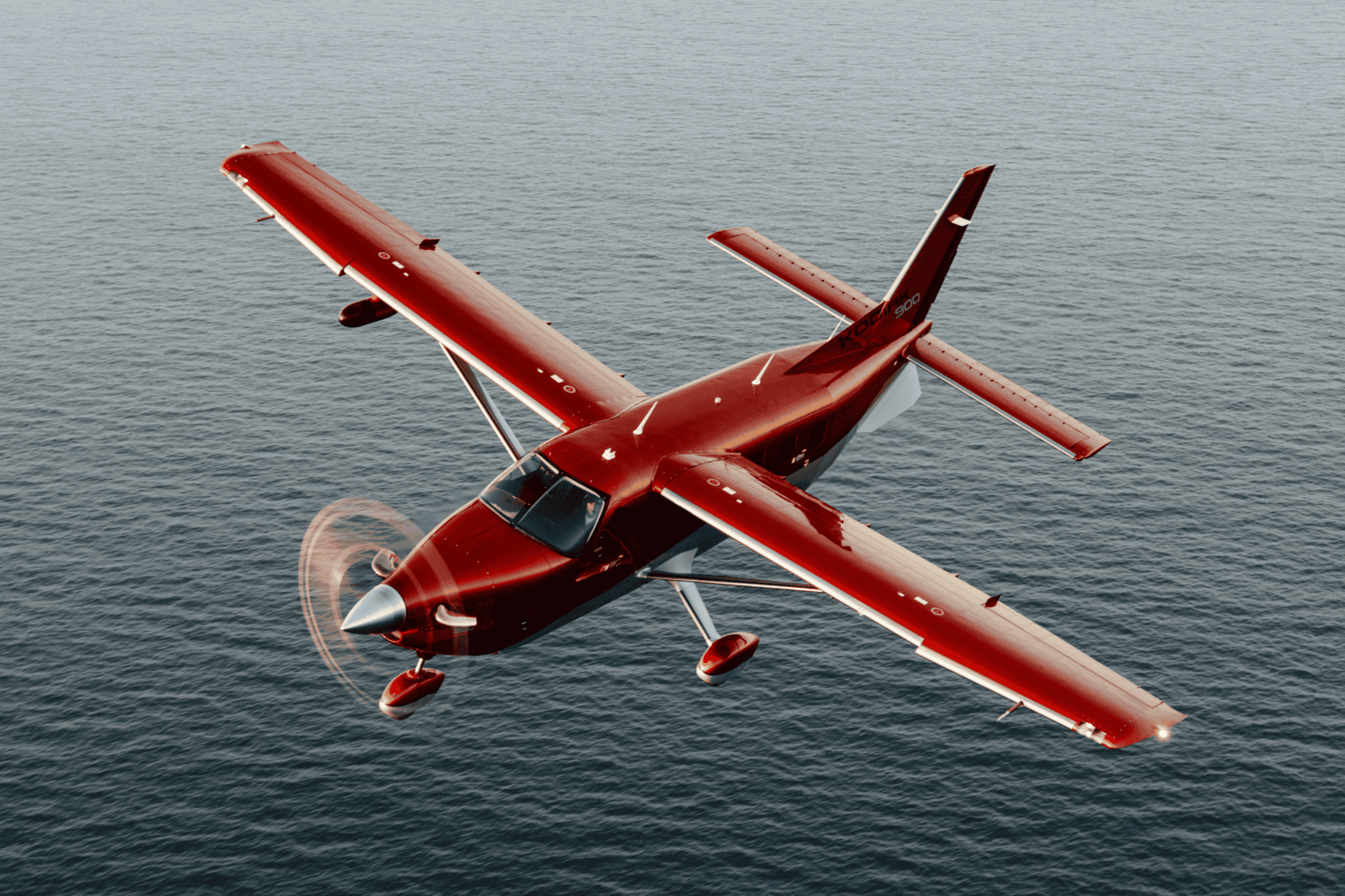 Red airplane flying over ocean
