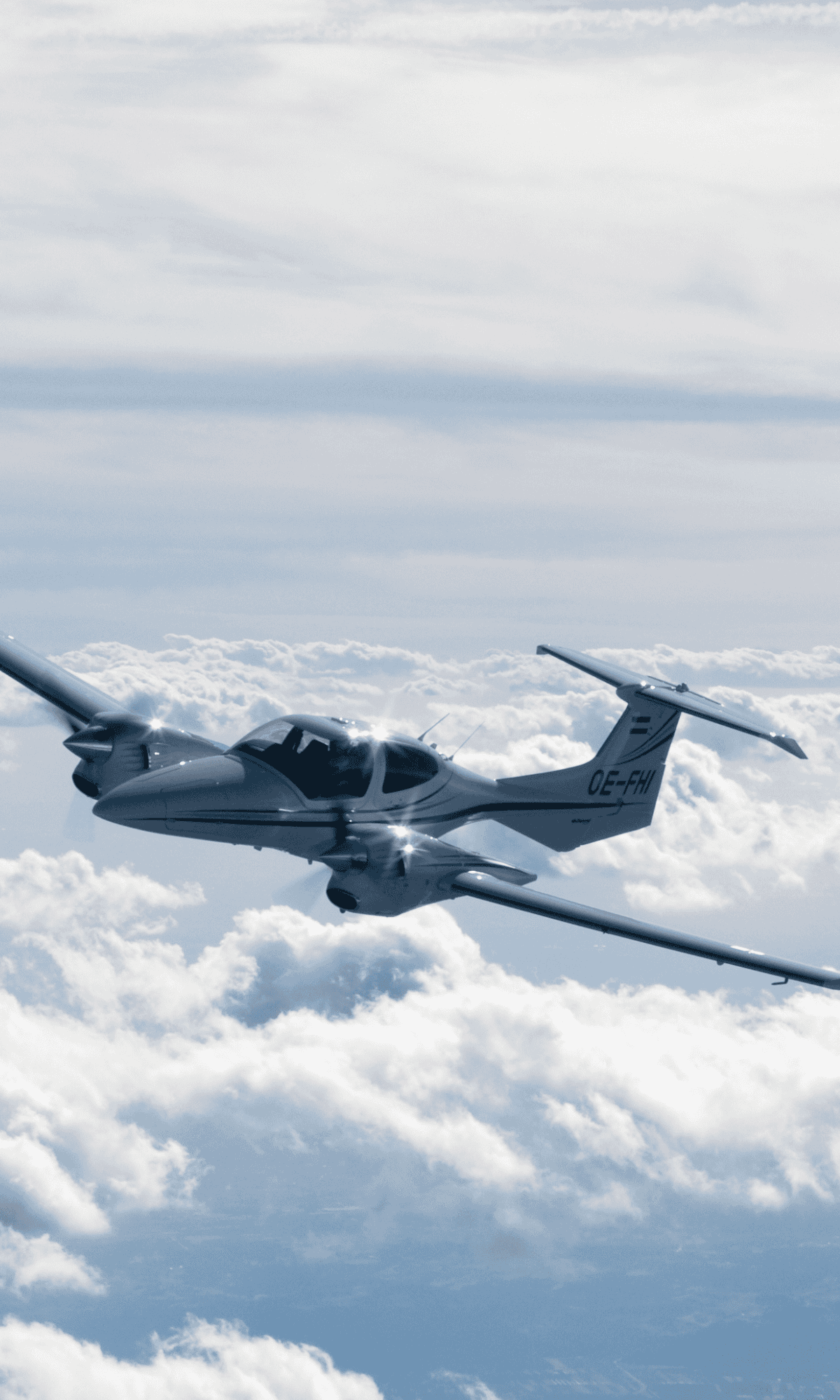 Small aircraft flying above clouds.