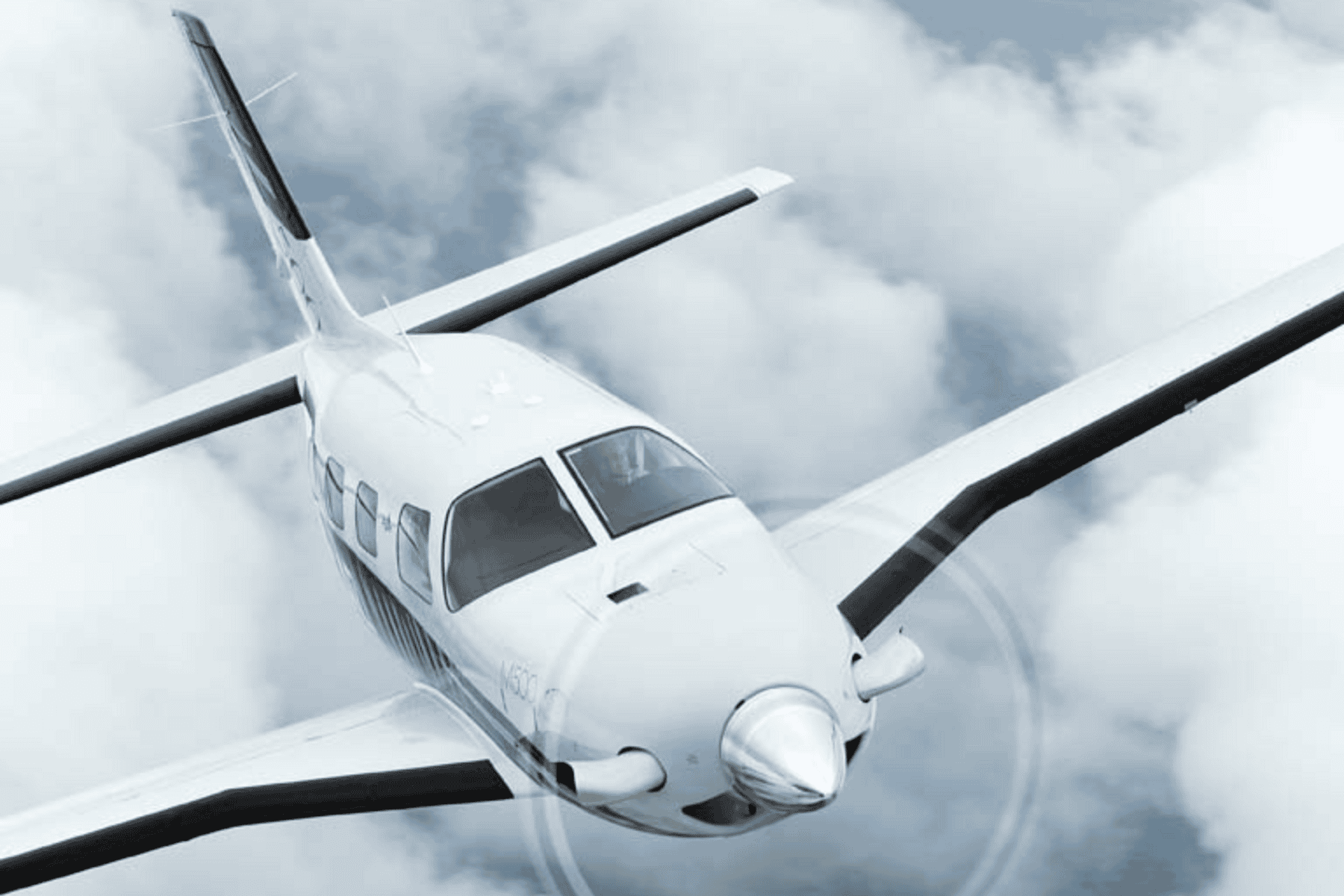 Small airplane flying above clouds