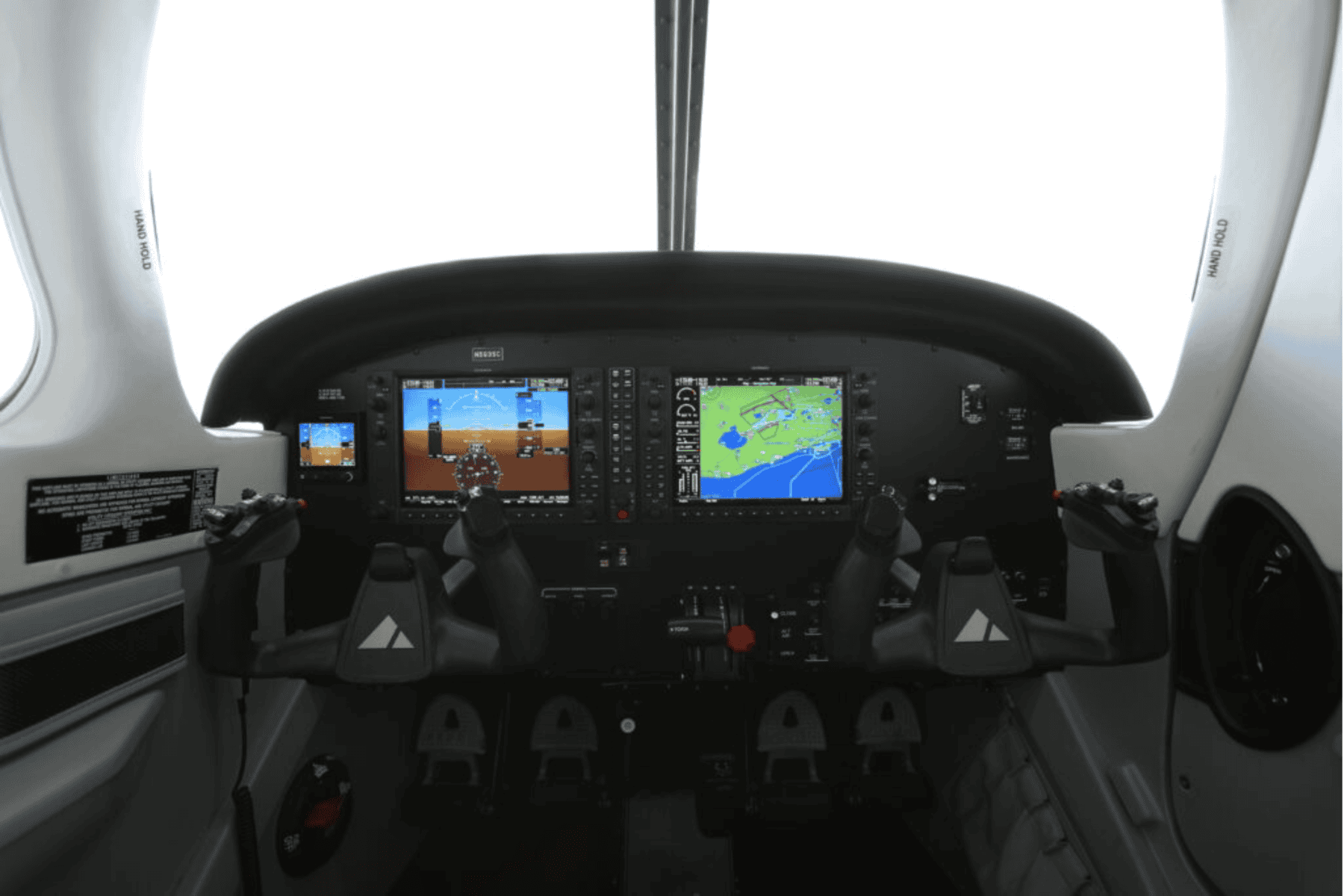 Aircraft cockpit with digital flight controls and displays.