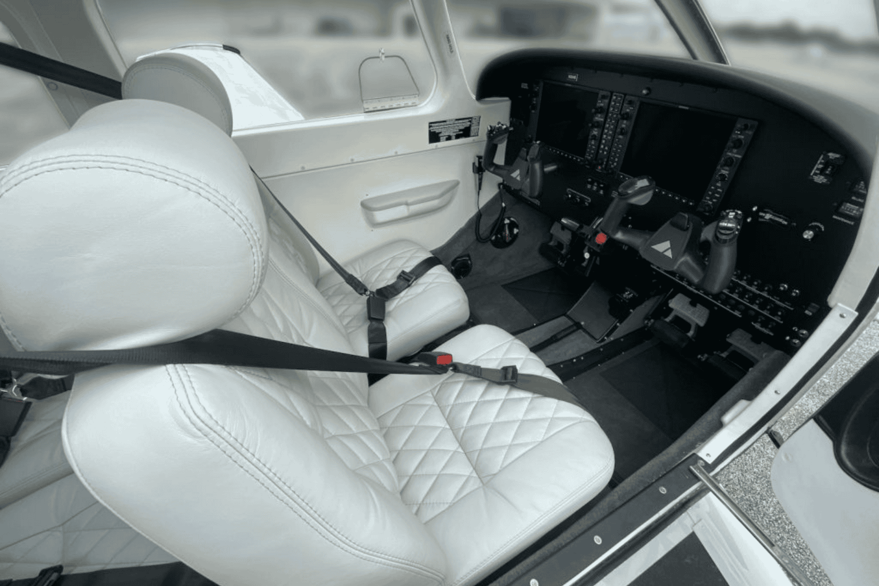 Private aircraft cockpit with white leather seats