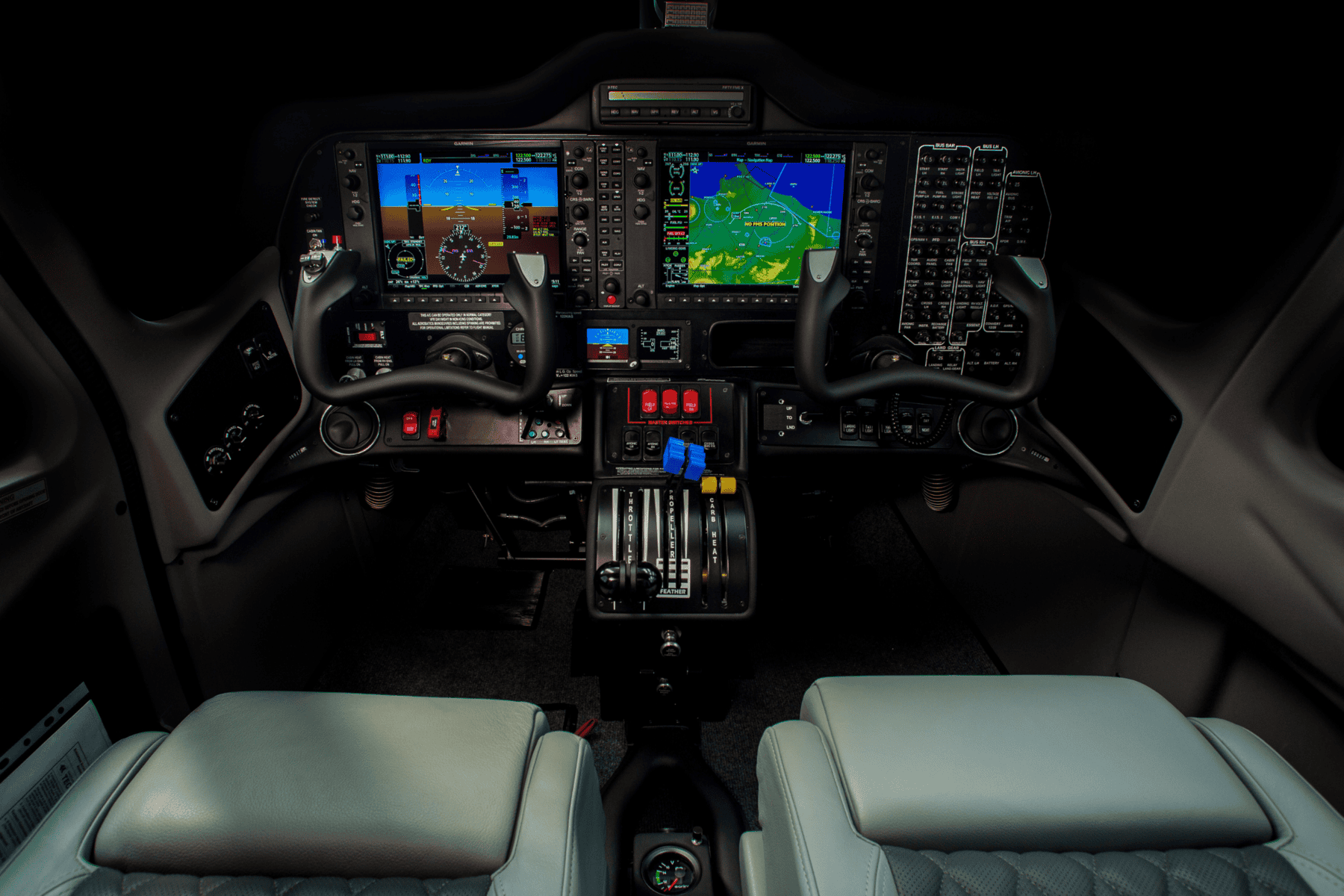Modern airplane cockpit with control panels.